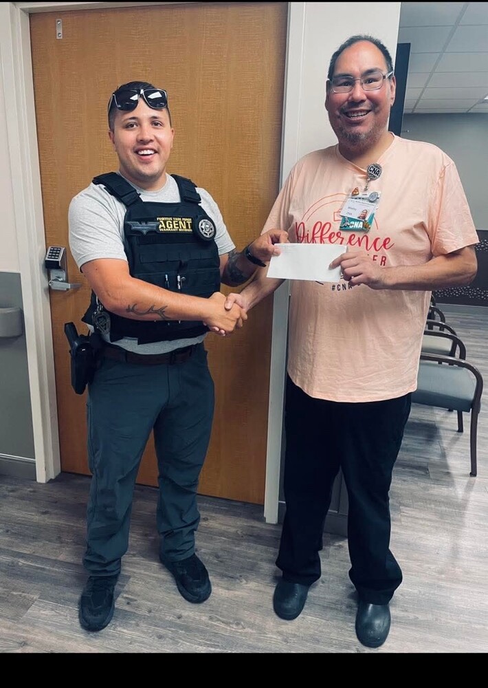 Joel Graf shaking hands with a Montana health care professional.