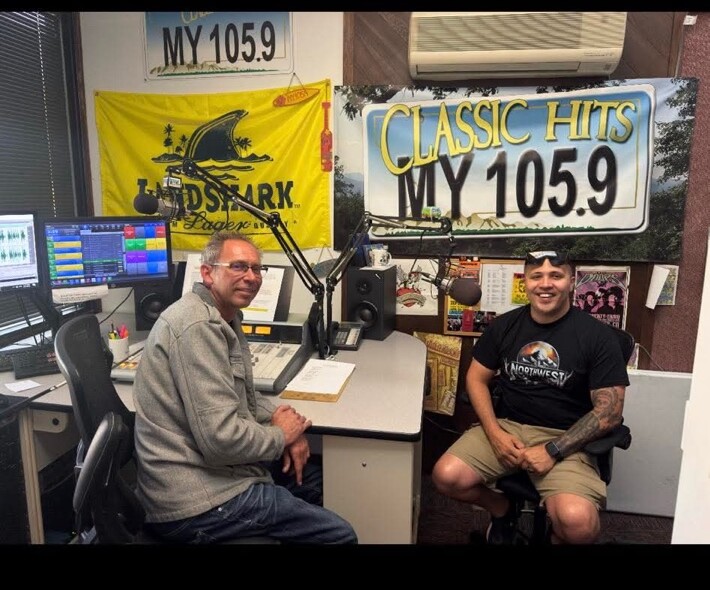 Joel Graf and a radio host seated in the MY 105.9 Classic Hits studio.